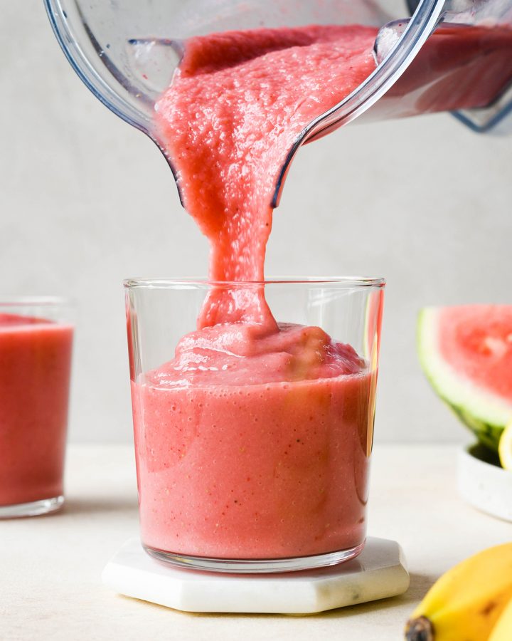 Watermelon Smoothie pouring out of a blending container into a glass