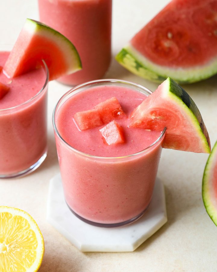 two glasses of Watermelon Smoothie with watermelon chunks and slices