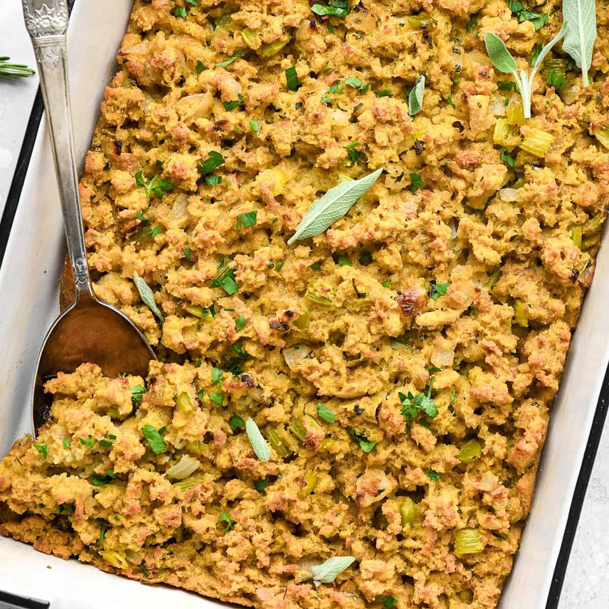 cornbread stuffing in a baking dish with a spoon 