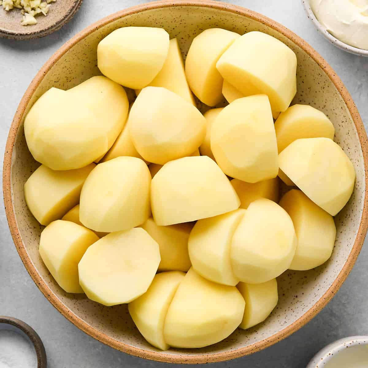 peeled and cut potatoes in a bowl to make this Cream Cheese Mashed Potatoes Recipe