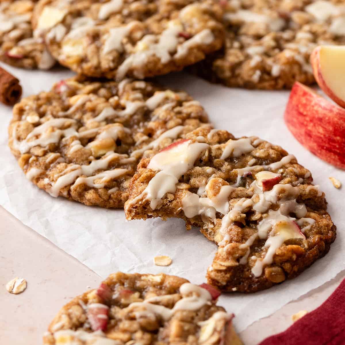 5 Oatmeal Apple Cookies with glaze, one has a bite taken out of it