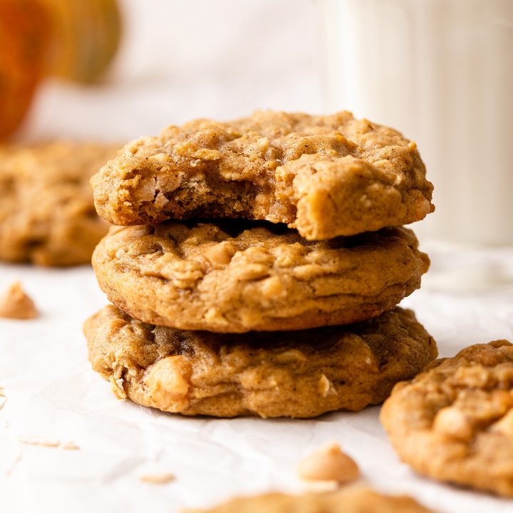 a stack of 3 Pumpkin Oatmeal Cookies, the top one has a bite taken out of it