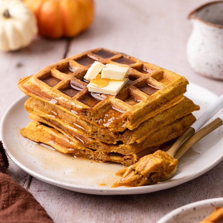 a stack of 4 Pumpkin Waffles with a bite taken out of them