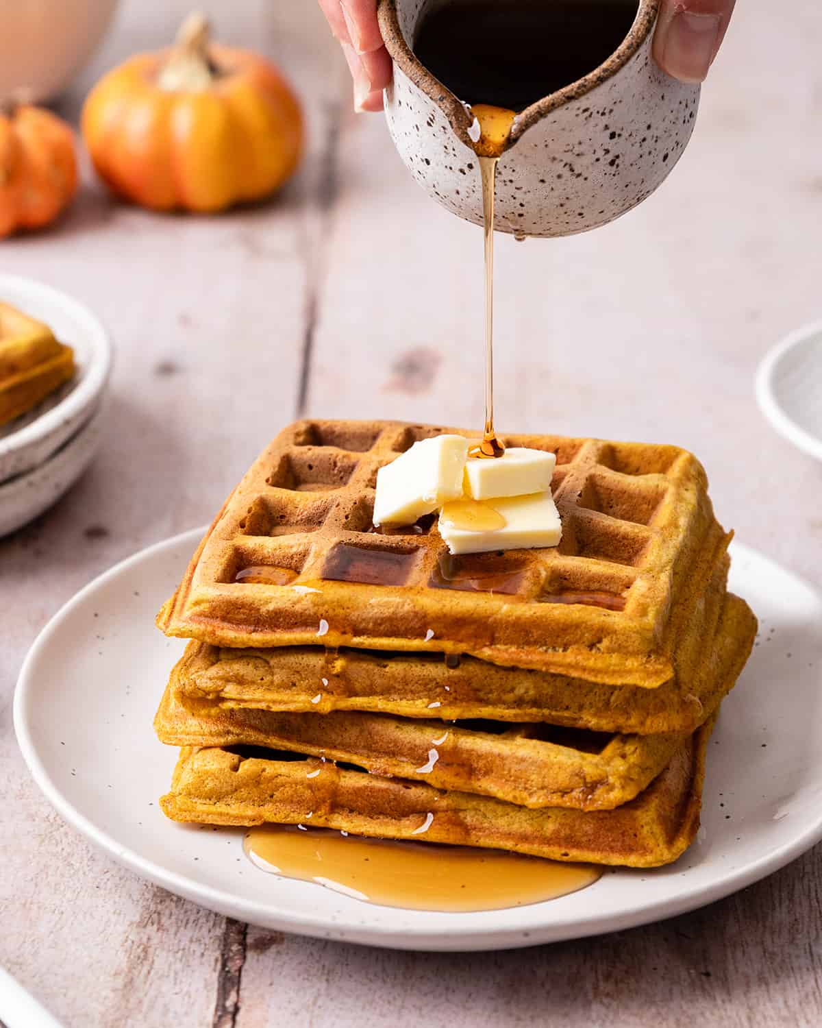 syrup pouring onto a stack of 4 Pumpkin Waffles 