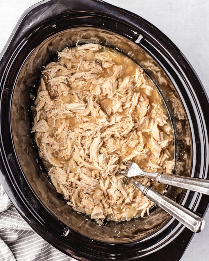 Slow Cooker Pulled Chicken in the crockpot with two forks