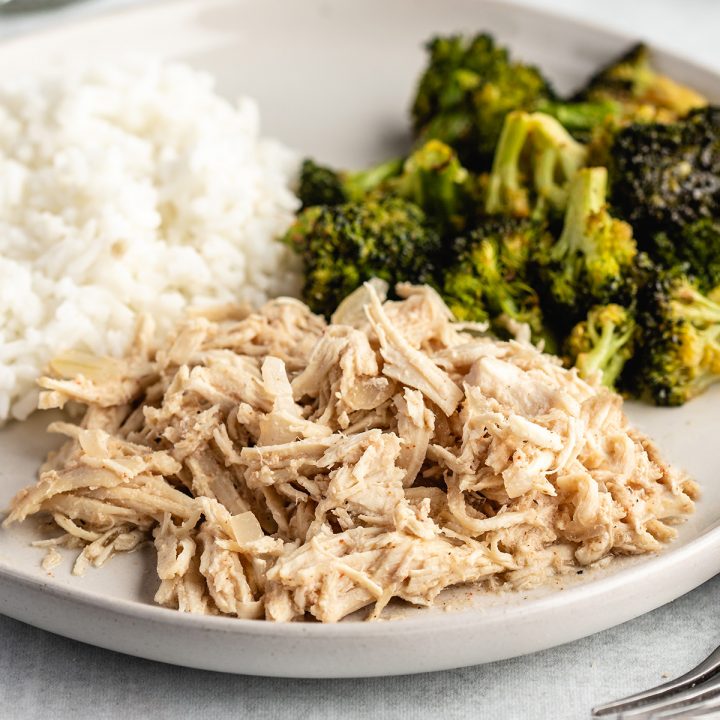 Slow Cooker Shredded Chicken on a plate with broccoli and rice