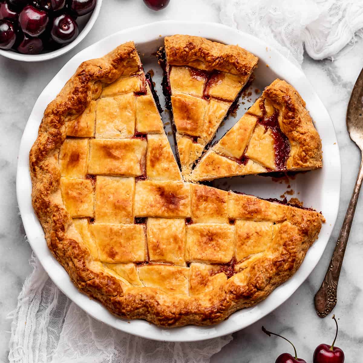 overhead view of a baked Cherry Pie with two slices cut out