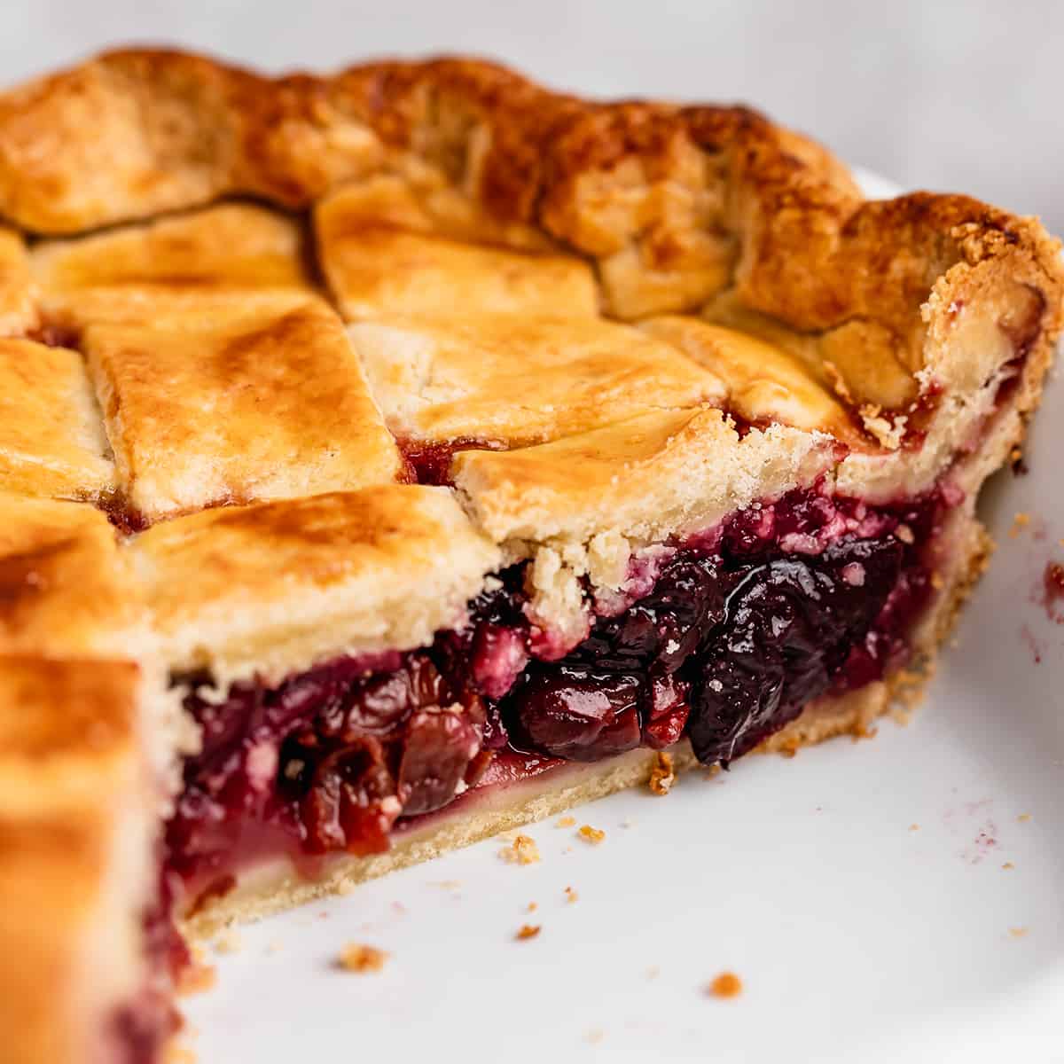Cherry Pie in a pie dish with slices cut out