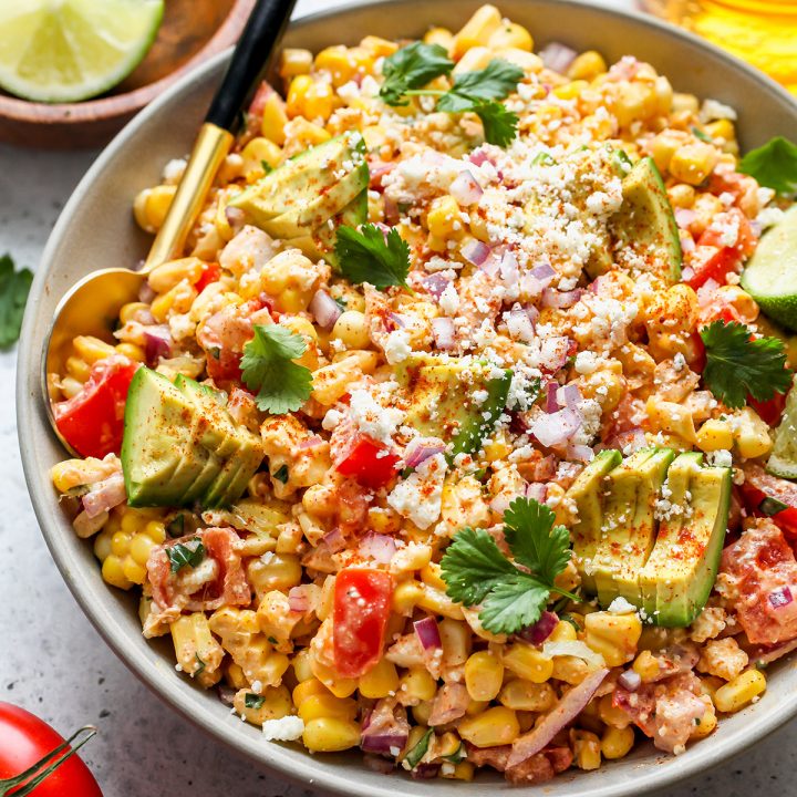 Mexican Corn Salad in a serving bowl with a spoon