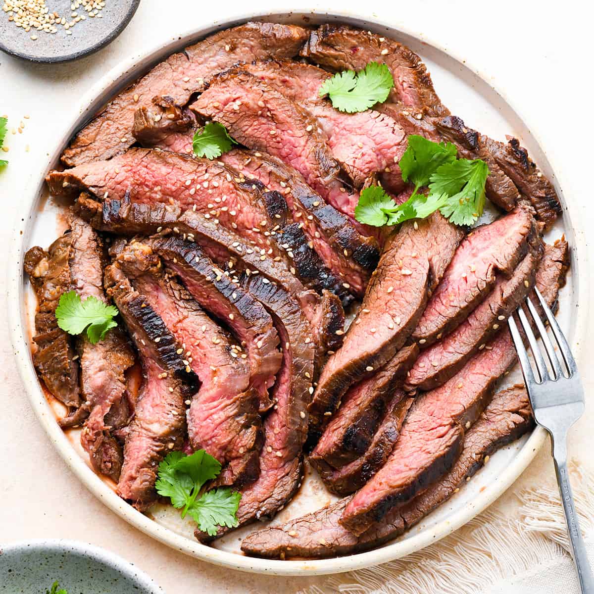 a plate full of slices of grilled flank steak 