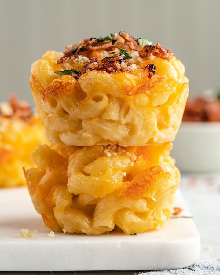 two Baked Mac & Cheese Cups stacked on top of each other. 