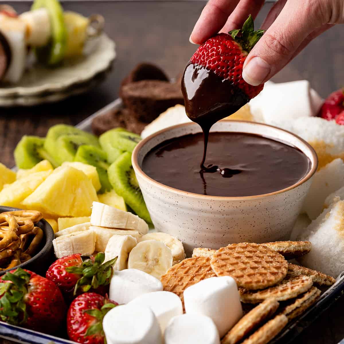 a strawberry being dipped into Chocolate Fondue