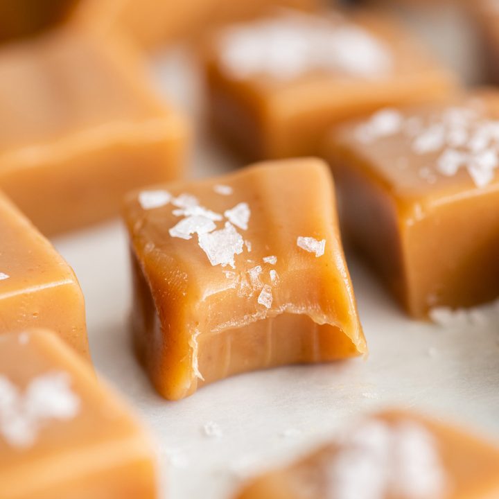 up close photo of a homemade caramel with a bite taken out of it 