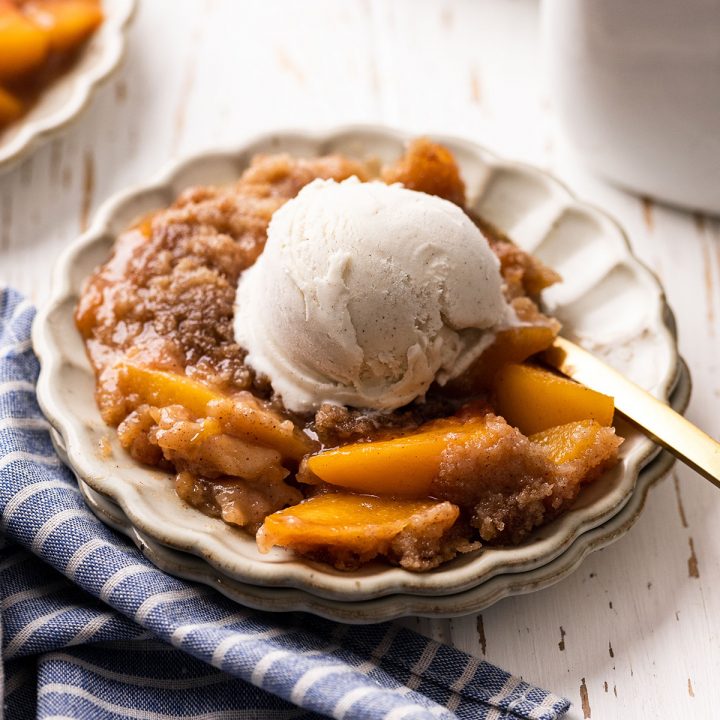 Peach Crumble on a plate with vanilla ice cream