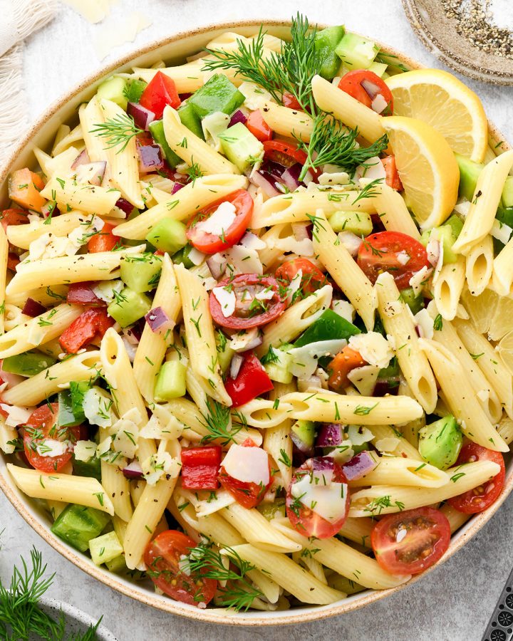 Lemon Summer Pasta Salad in a large serving bowl garnished with dill