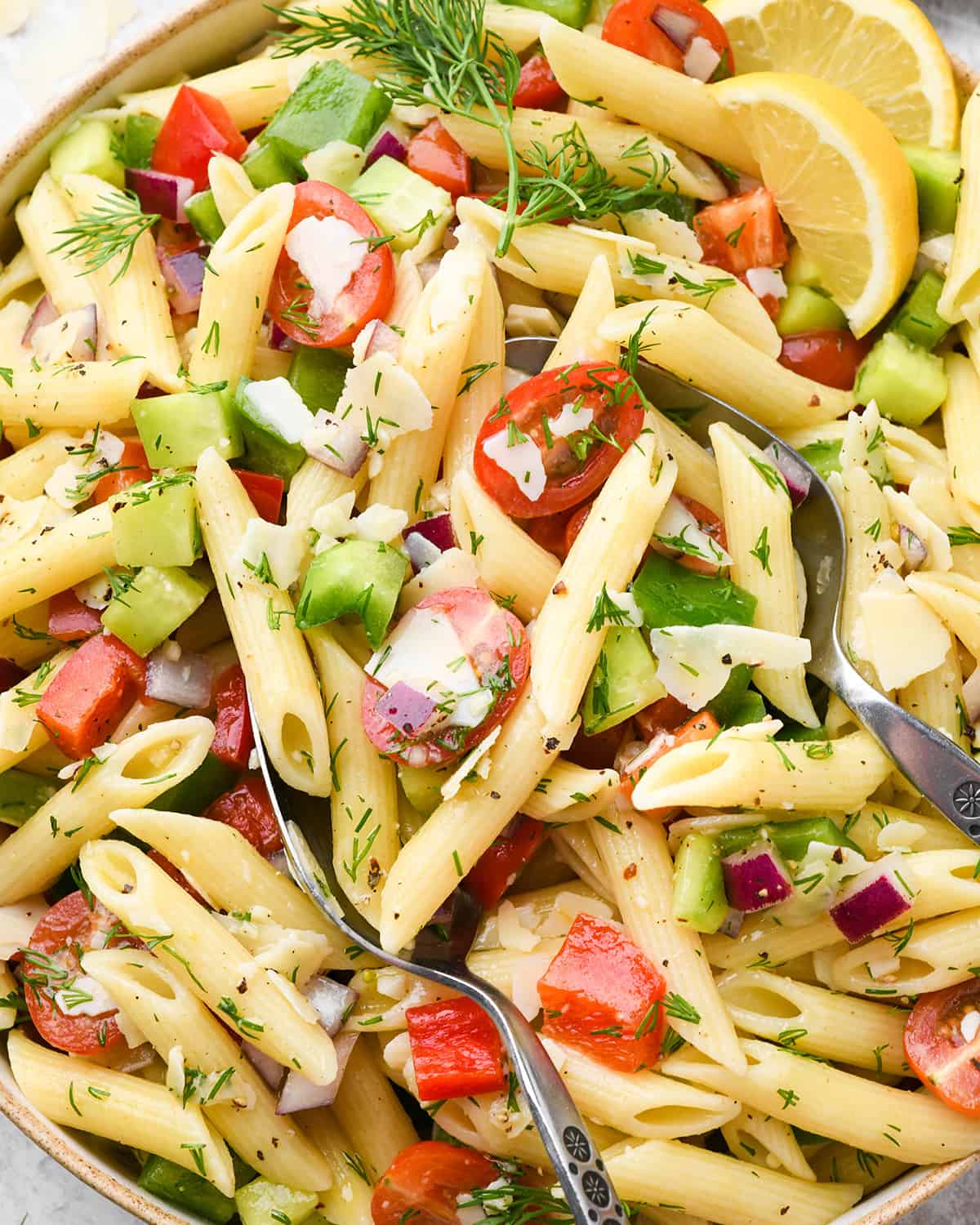 a bowl of Lemon Summer Pasta Salad with serving spoons