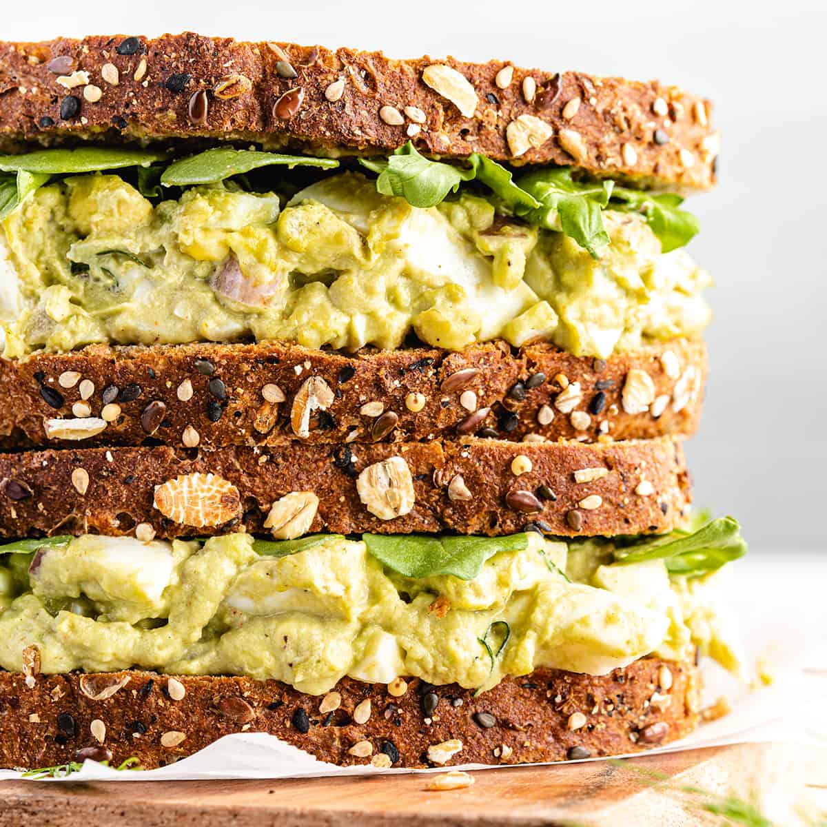 two Avocado Egg Salad sandwiches stacked on top of each other