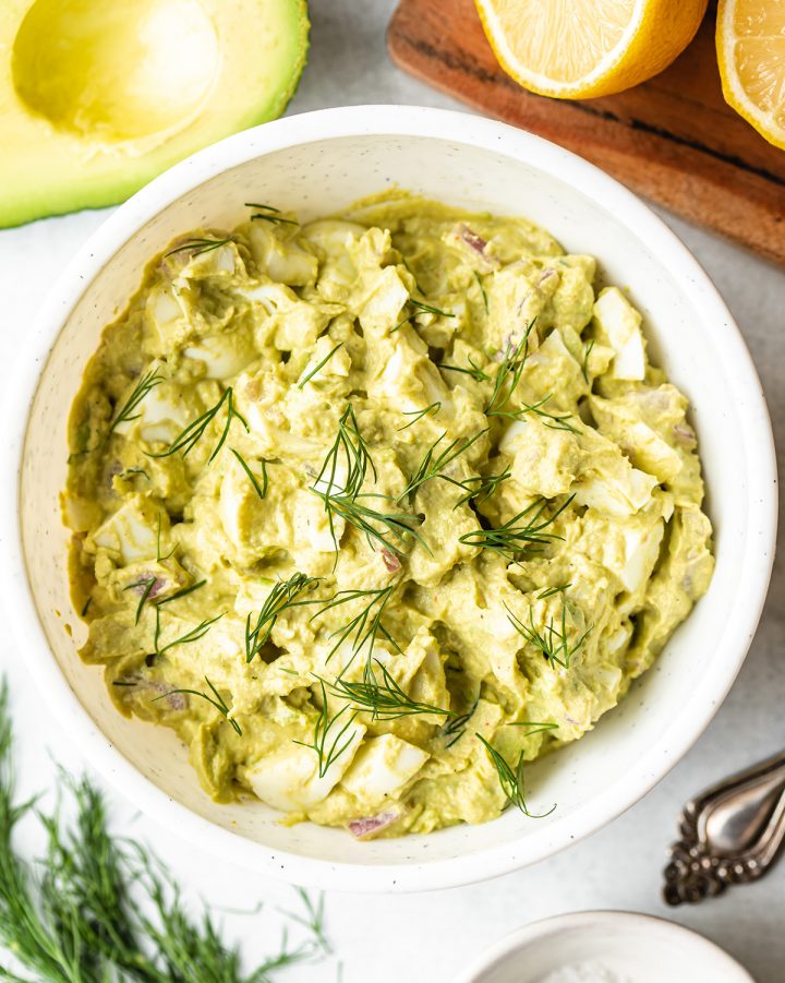a bowl of Avocado Egg Salad topped with fresh dill