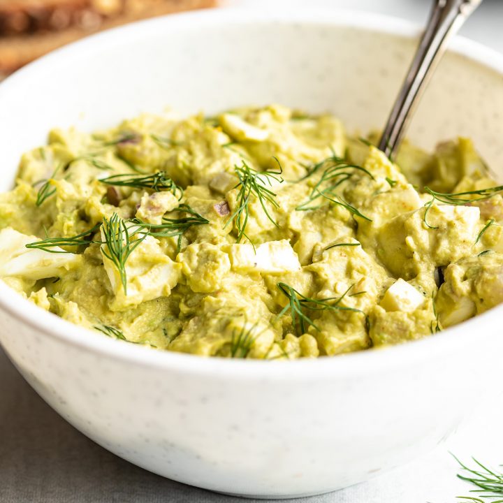 a bowl of Avocado Egg Salad topped with fresh dill