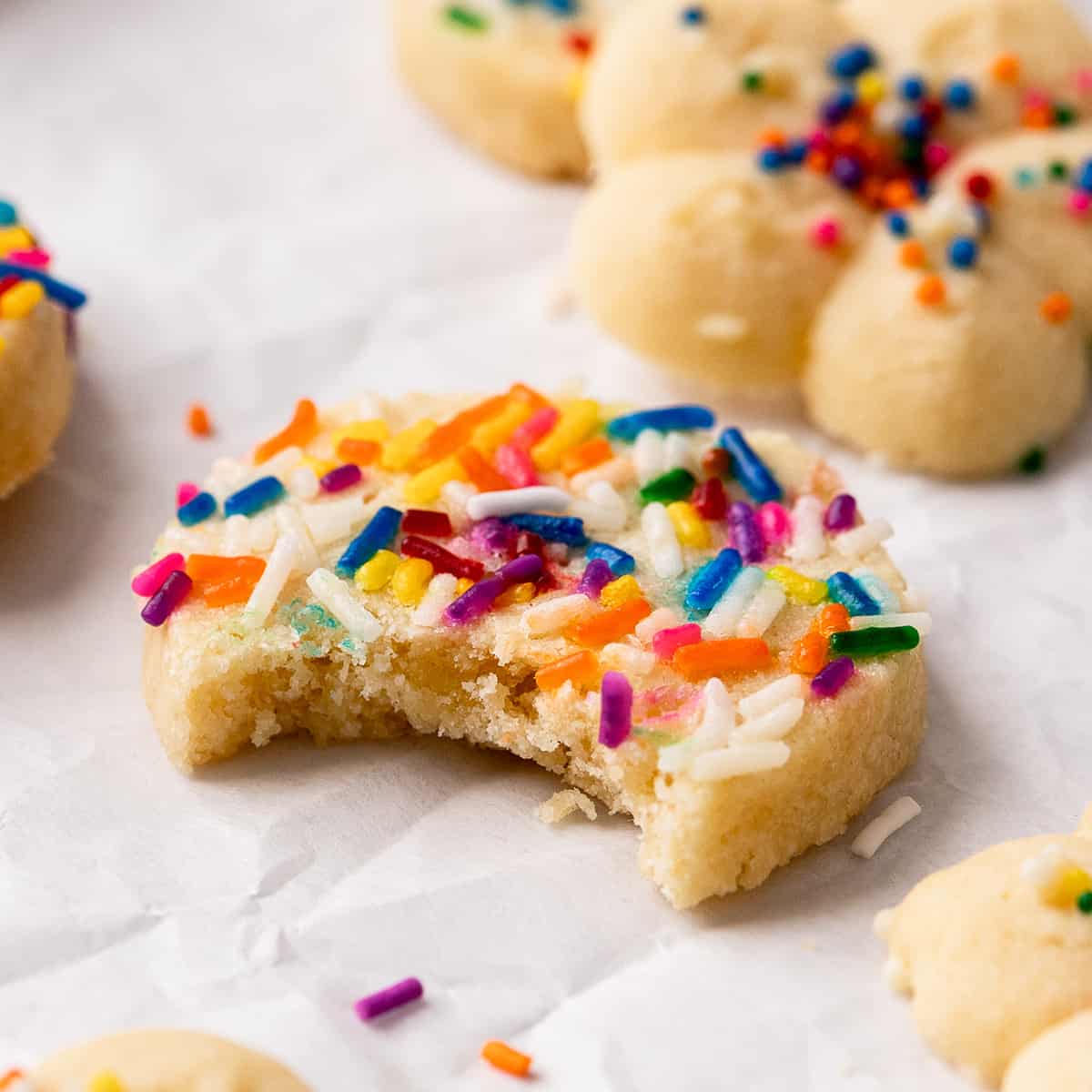 a Butter Cookies with sprinkles and a bite taken out of it