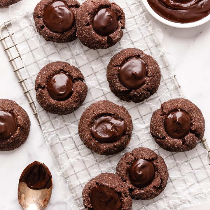 9 Chocolate Thumbprint Cookies on a cooling rack 