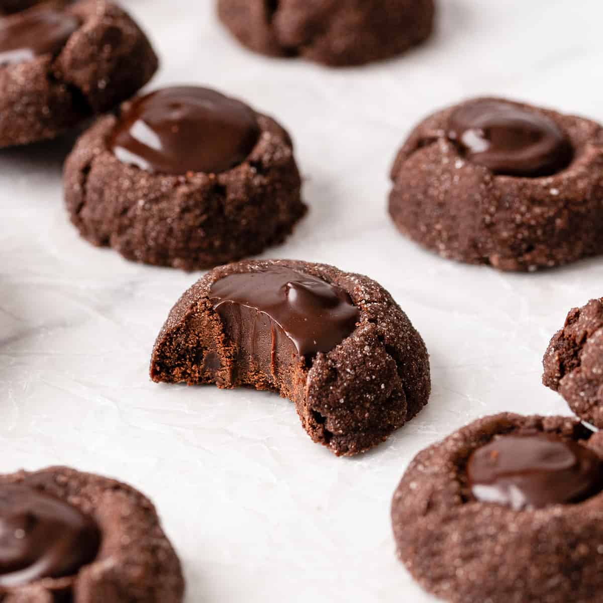 5 Chocolate Thumbprint Cookies, one with a bite taken out of it