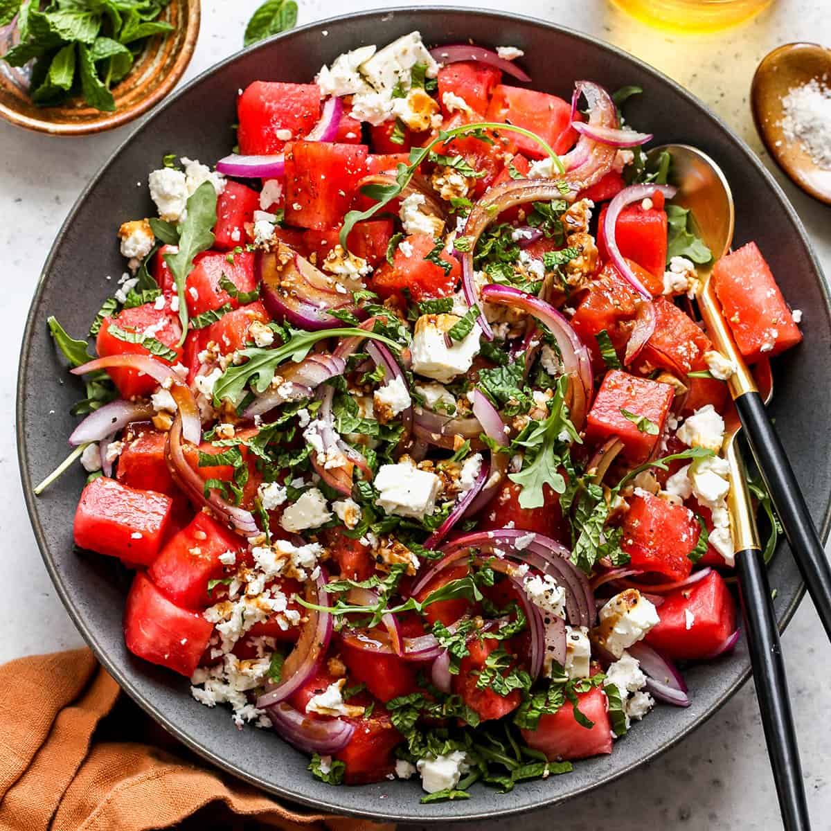 Feta Watermelon Salad in a serving bowl with salad servers