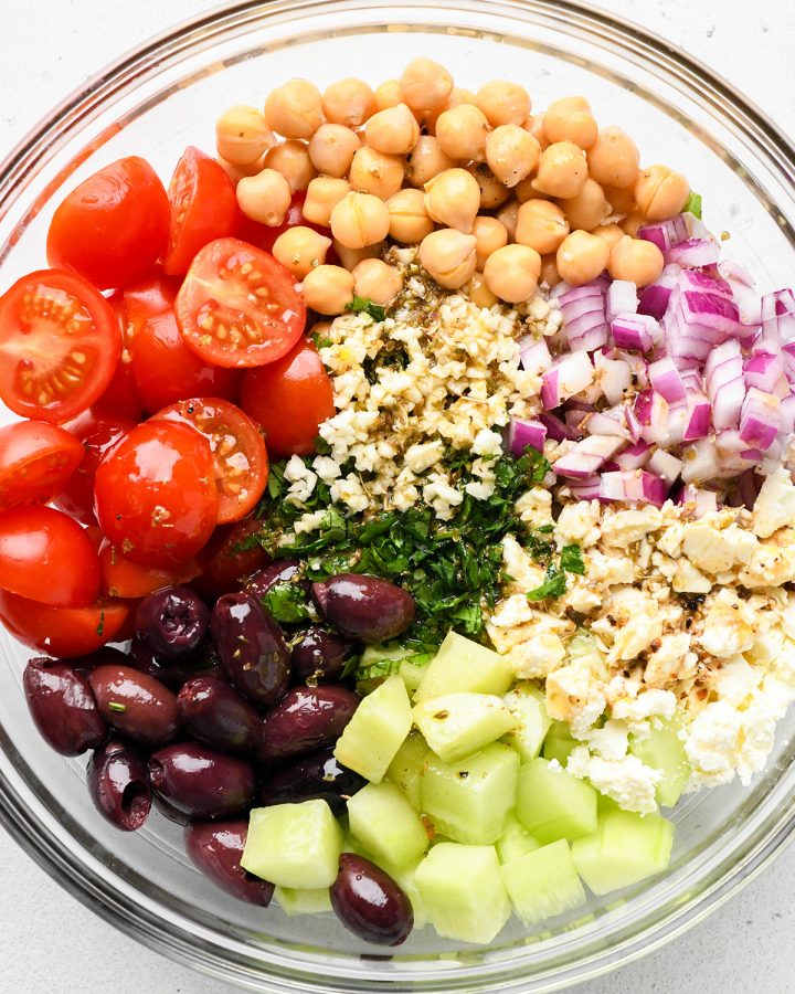 How to Make Chickpea Salad - combining ingredients in a glass bowl