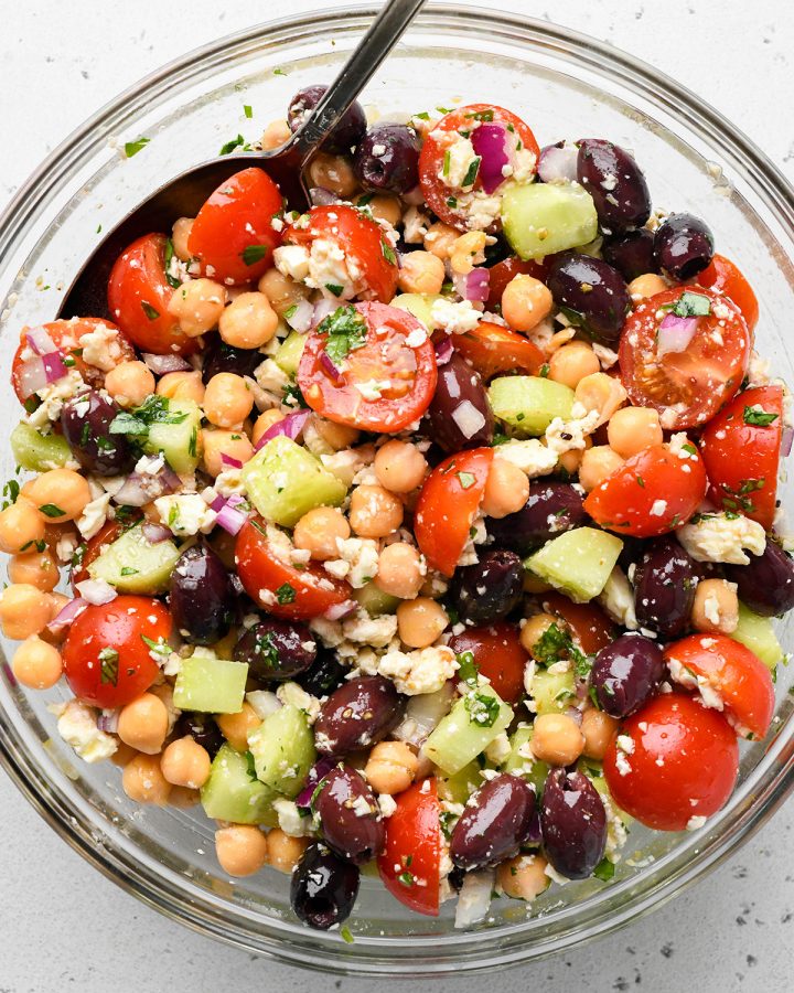 How to Make Chickpea Salad - stirring the ingredients with dressing