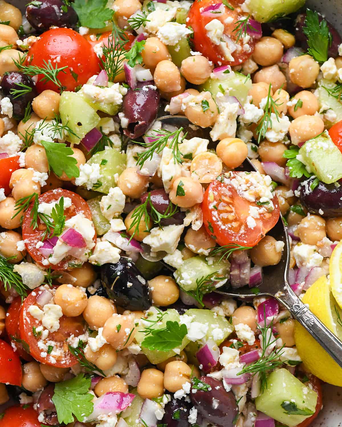 up close photo of a spoon taking a scoop of this chickpea salad recipe