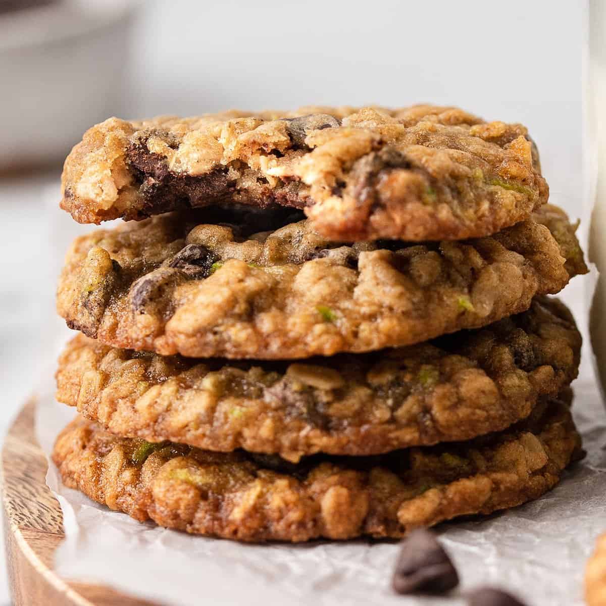 a stack of 4 Zucchini Chocolate Chip Cookies - the top one has a bite taken out of it