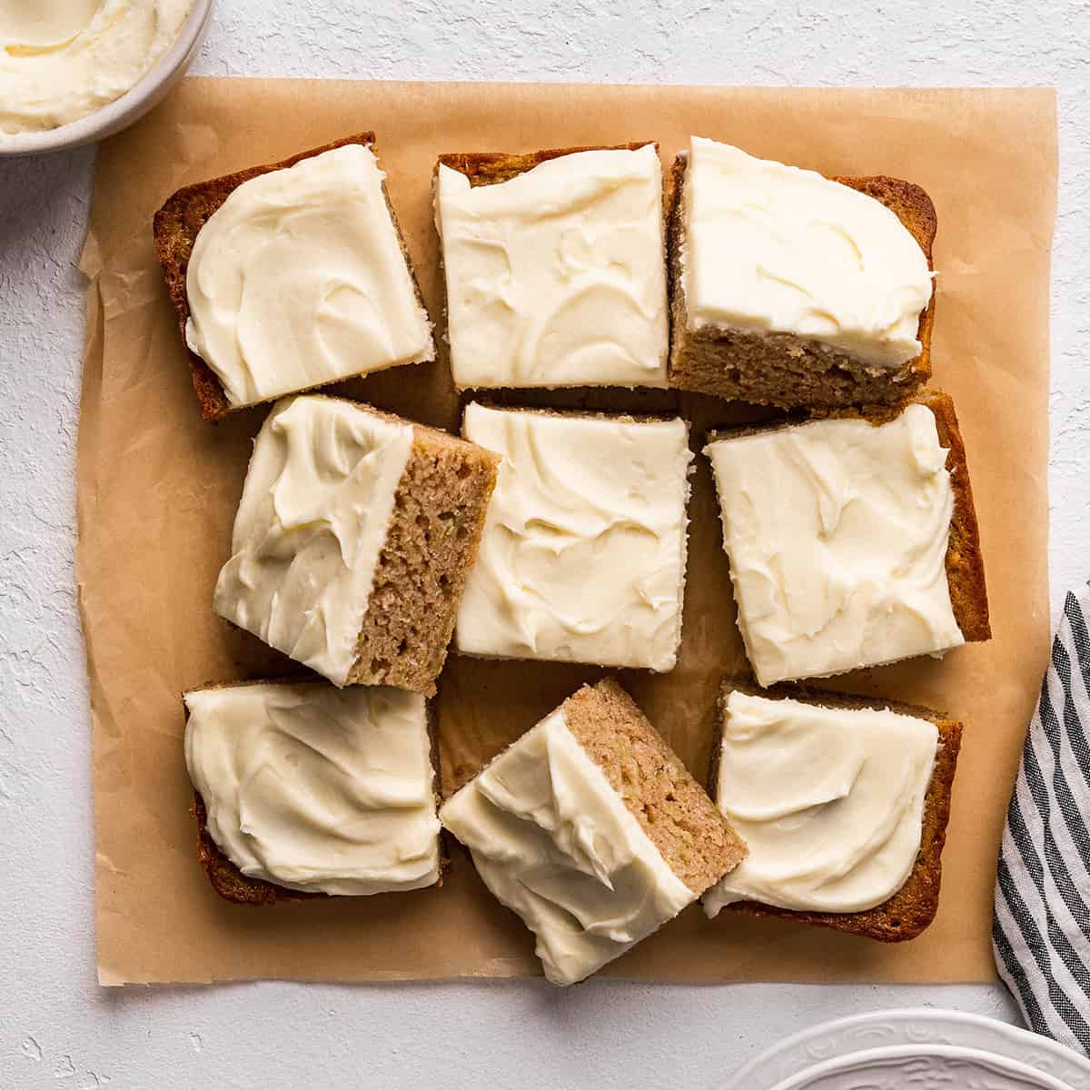 9 Zucchini Bars with cream cheese frosting cut into squares