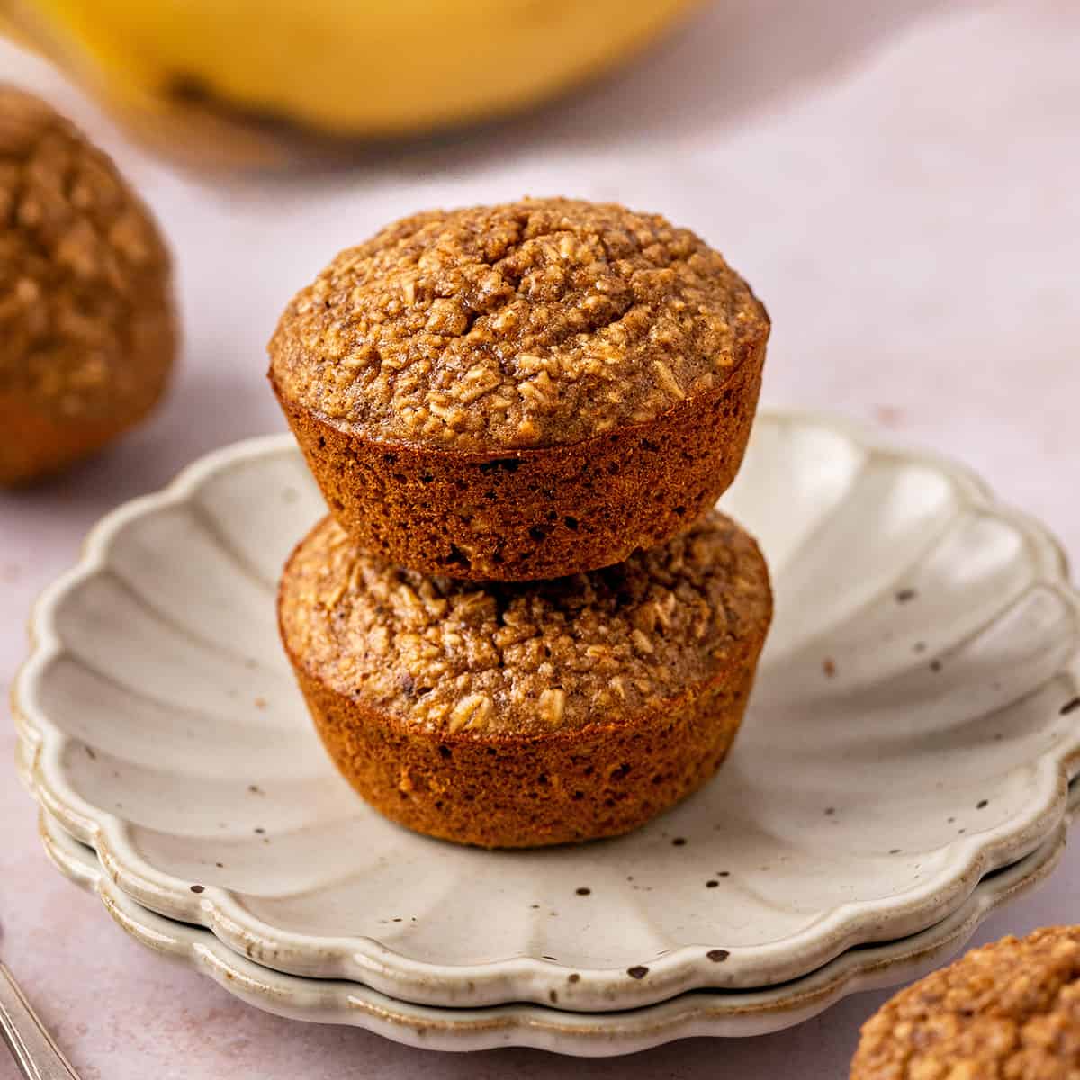 a stack of 2 Banana Oatmeal Muffins on a plate