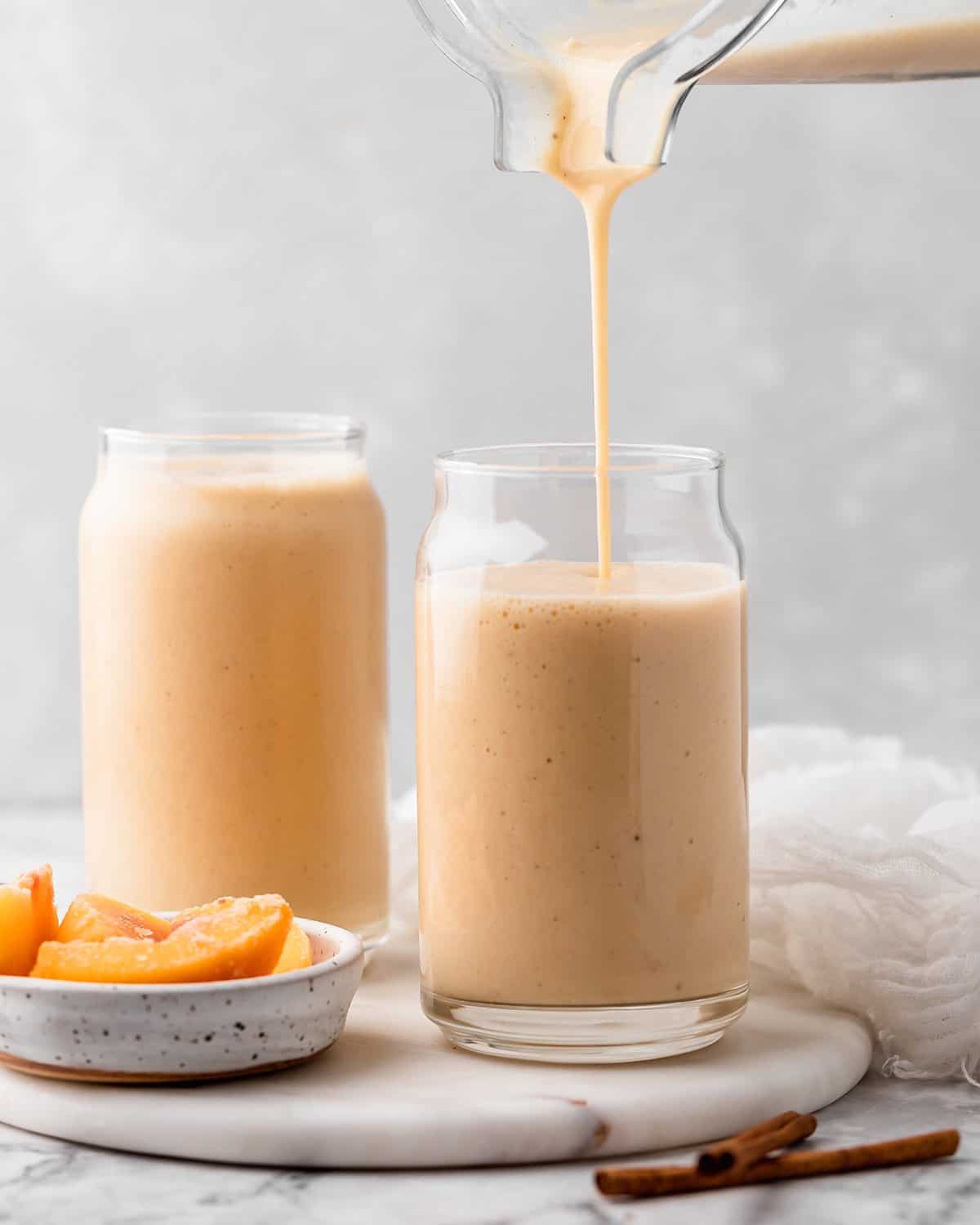 Banana Peach Smoothie being poured into a glass