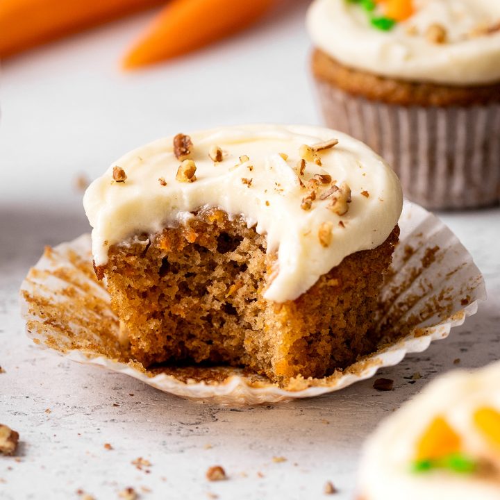 a Carrot Cake Cupcake with a bite taken out of it