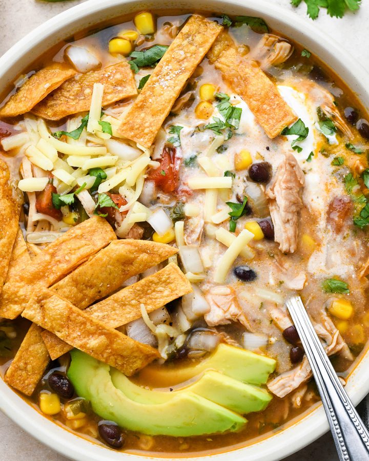 a Chicken Tortilla Soup with a spoon