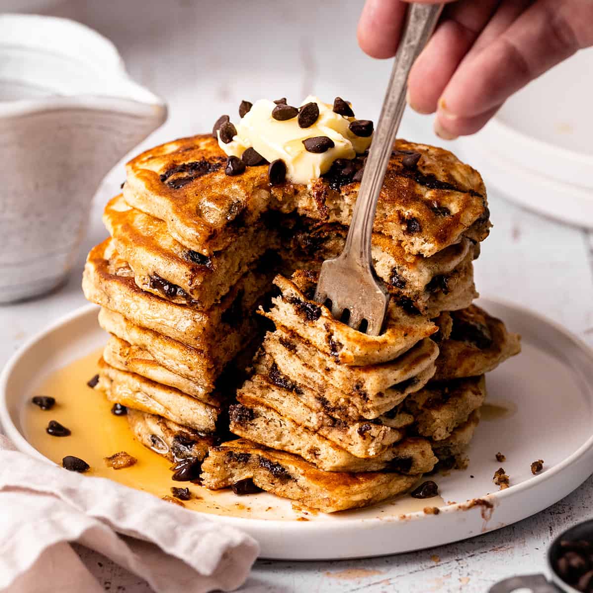 a fork taking a bite out of a stack of Chocolate Chip Pancakes