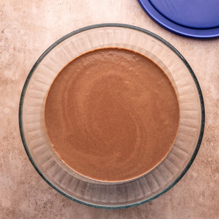 Chocolate crepe batter in a glass bowl to chill