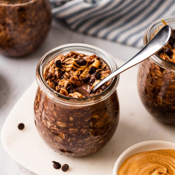 a jar of Chocolate Peanut Butter Overnight Oats with a spoon in it