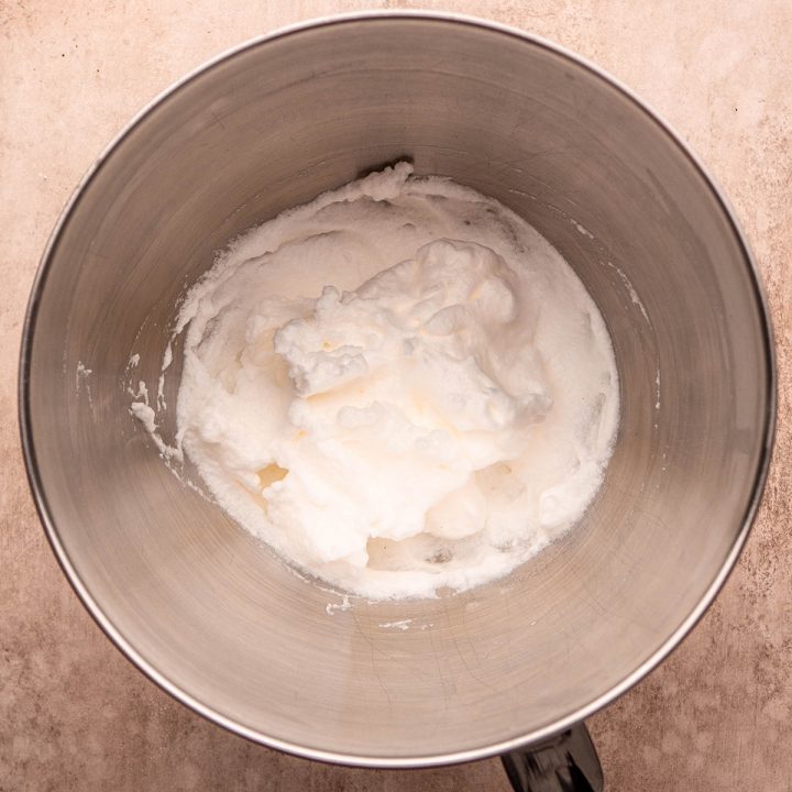 whipped egg whites in a mixing bowl to be used to make this chocolate waffles recipe