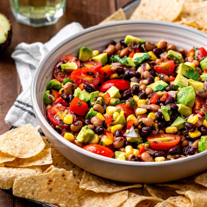 a bowl of Cowboy Caviar surrounded by chips