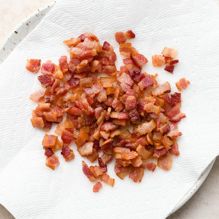 diced and cooked bacon on a plate lined with a paper towel to use in this potato soup recipe 