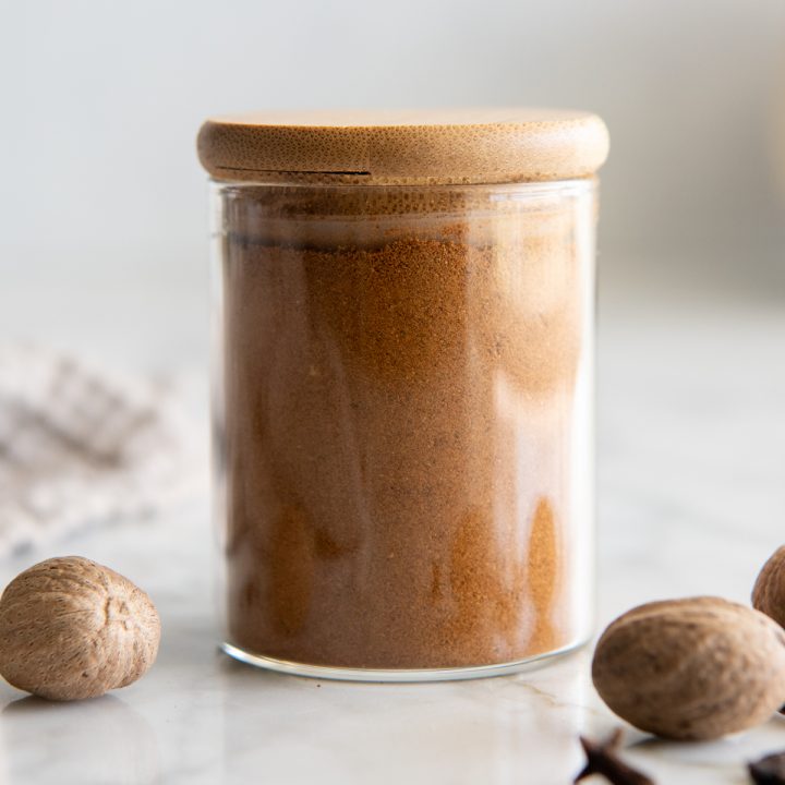 a glass jar of Homemade Pumpkin Pie Spice with a wooden lid 