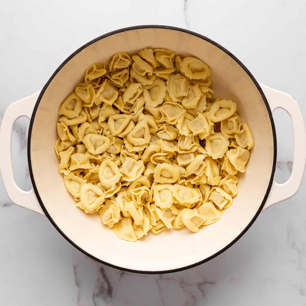 a pot of cooked tortellini noodles