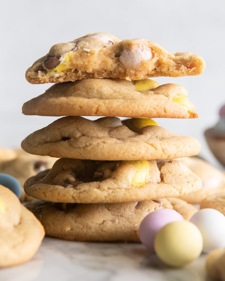stack of 5 Mini Egg Cookies, the top one with a bite taken out of it so you can see the insdie