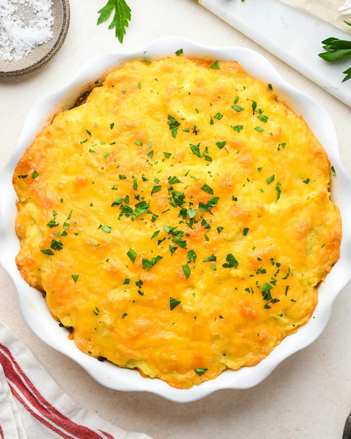 Shepherd's Pie Recipe in a pie dish after baking, garnished with parsley