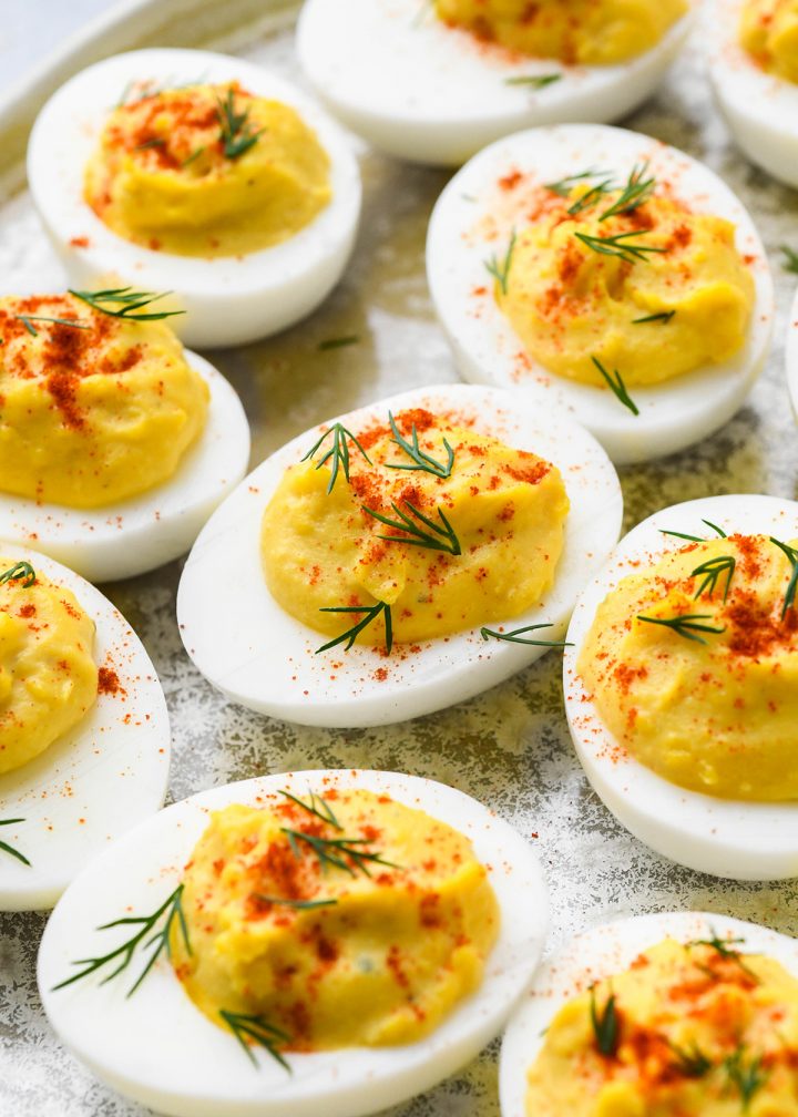 9 Deviled Eggs garnished with dill and paprika