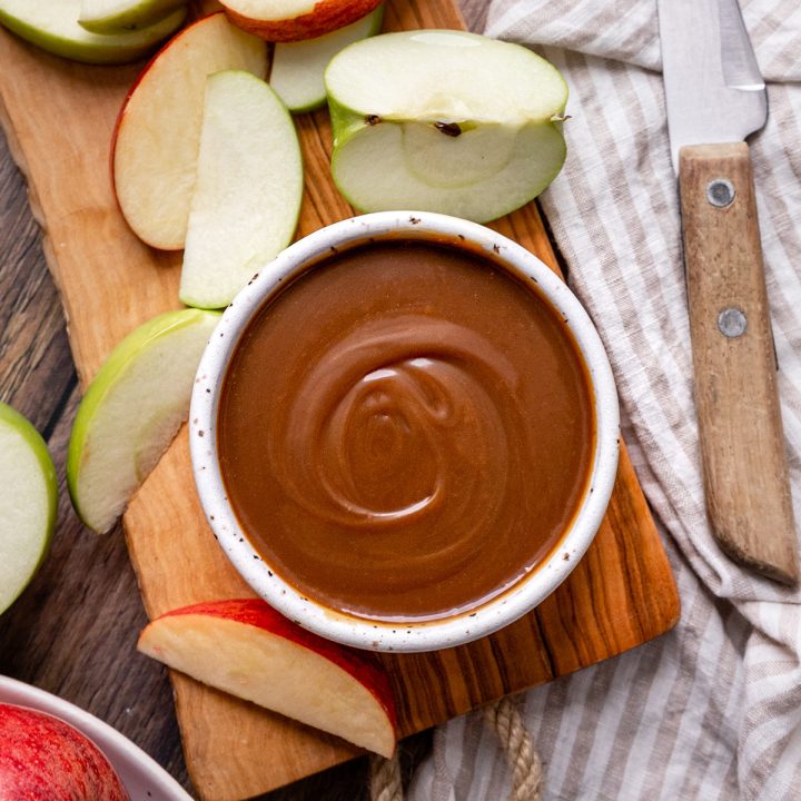 Caramel Apple Dip in a bowl surrounded by apples