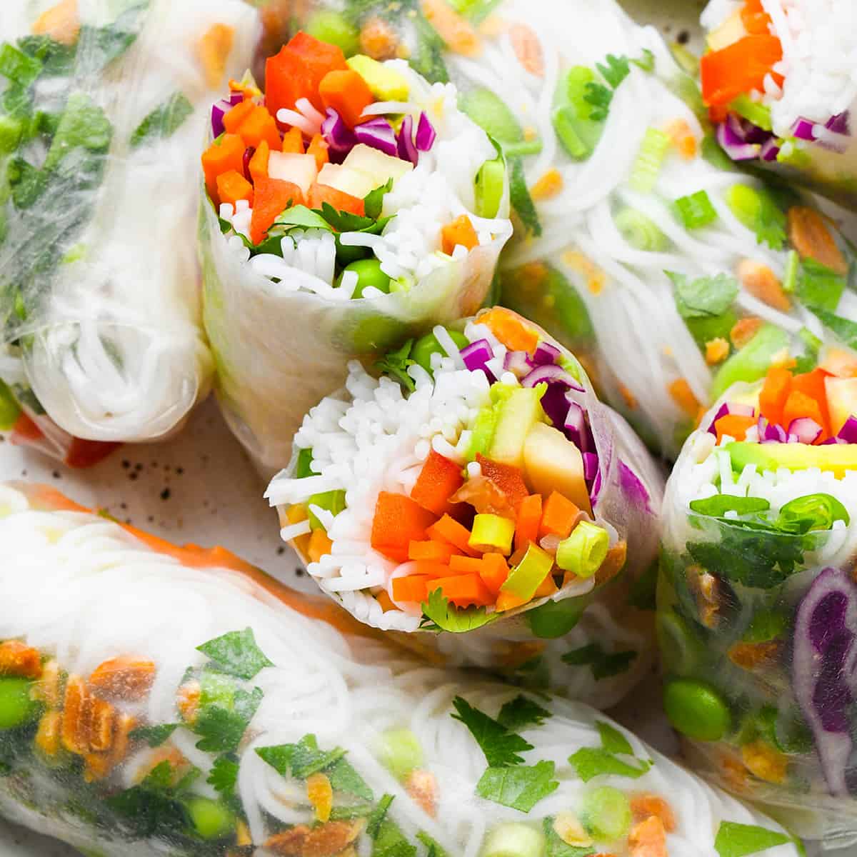 photo of a spring roll cut in half surrounded by other Spring Rolls