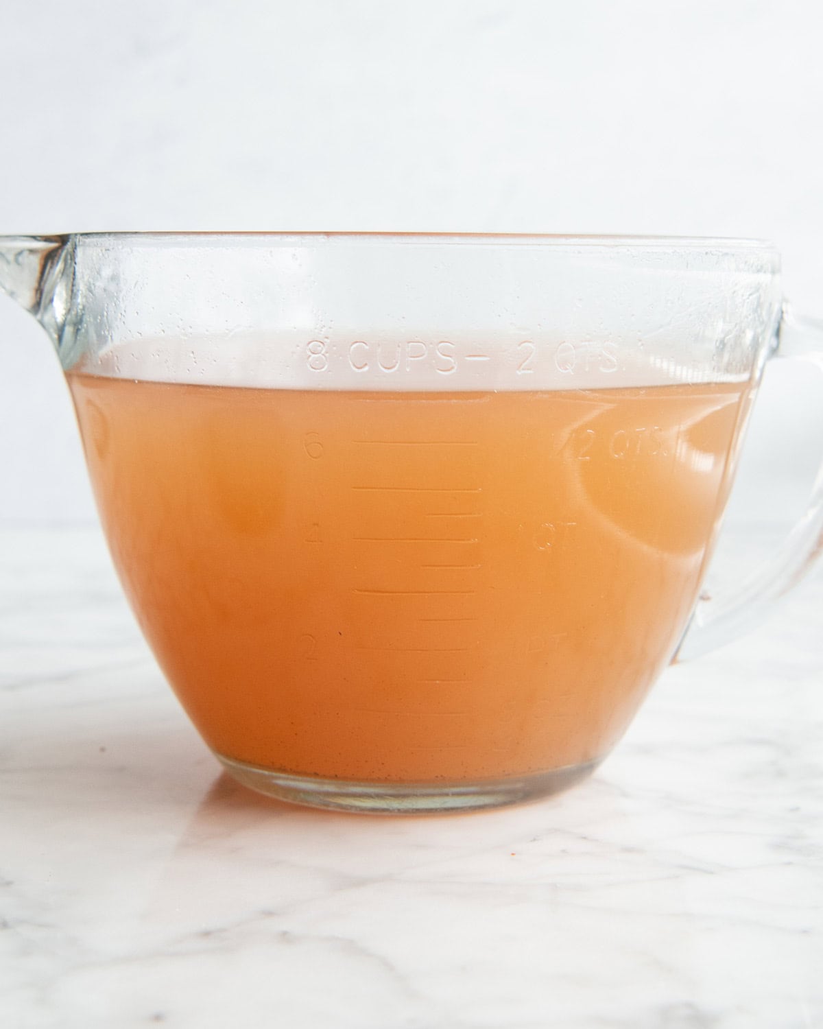 apple cider in a 8 cup glass measuring cup 
